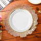white gold trimmed dinner plate on top of a Filigree Acrylic Charger Plate Gold 