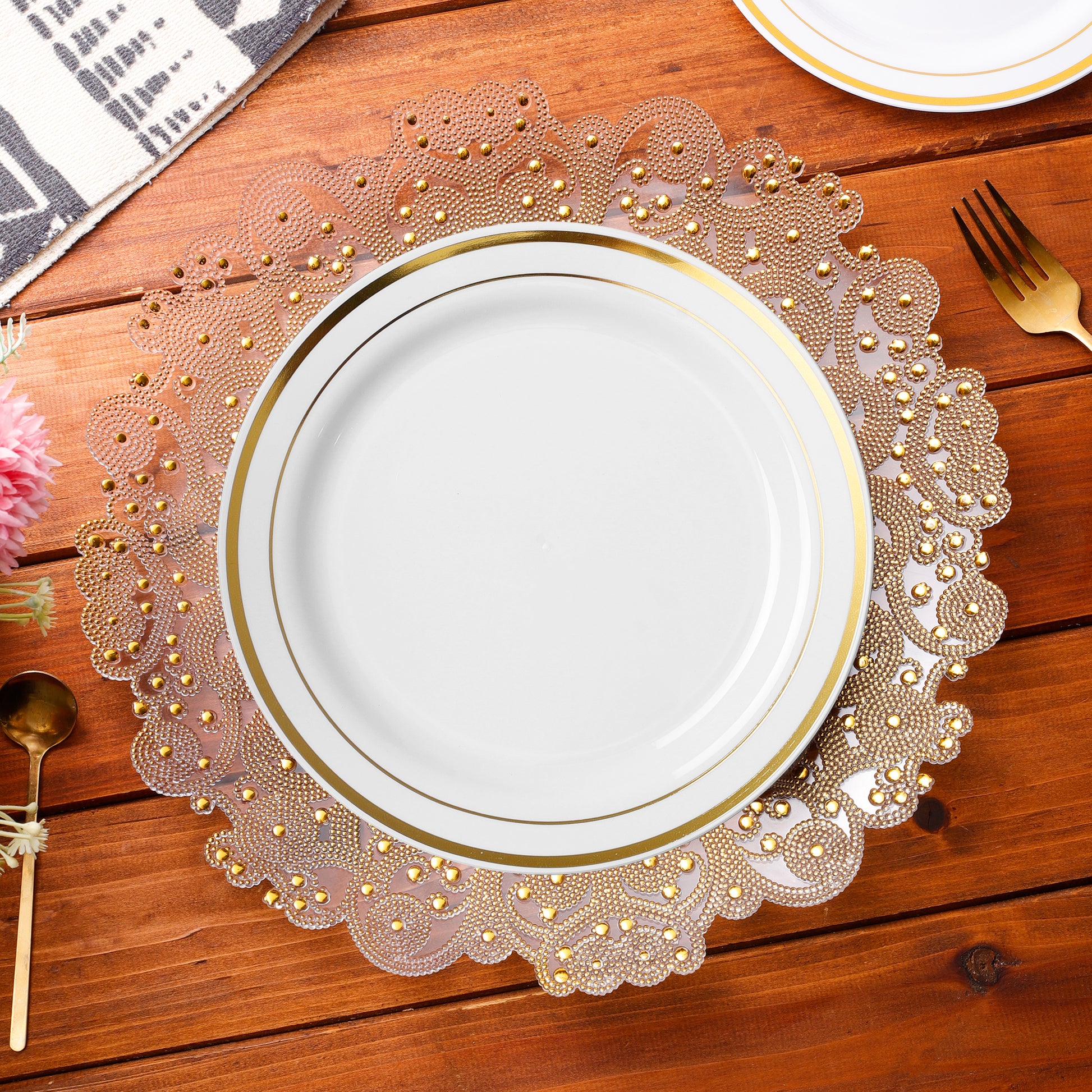 white gold trimmed dinner plate on top of a Filigree Acrylic Charger Plate Gold 
