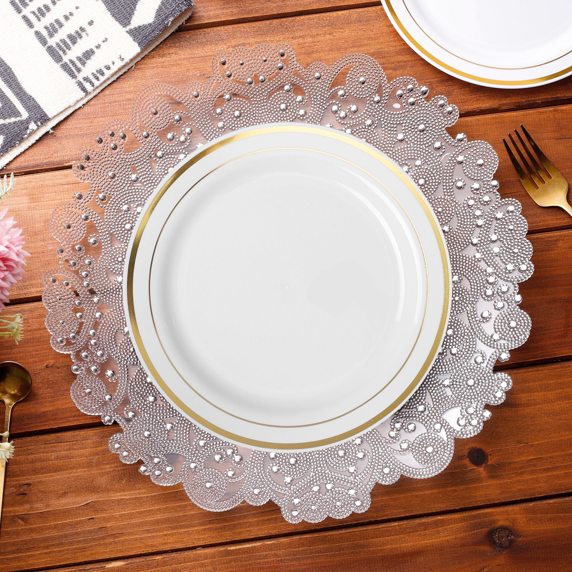 Filigree Acrylic Charger Plate Silver with a white fold trimmed dinner plates on top
