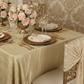 vintage glamour close up view using Accordion Crinkle Taffeta - 90"x132" Rectangular Tablecloth - Champagne with gold charger plate