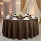 Accordion Crinkle Taffeta Round Tablecloth Chocolate on a round table with wine glasses, ivory napkins and floral centerpieces
