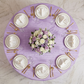 birds eye view of the Accordion Crinkle Taffeta Round Tablecloth Lavender on a round with white gold trimmed dinner plates and water glasses