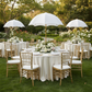 Garden brunch with the Adjustable Umbrella Centerpiece Stand White Cover with floral around the base on top of a premium satin (wrinkle-resistant) ivory round tablecloth