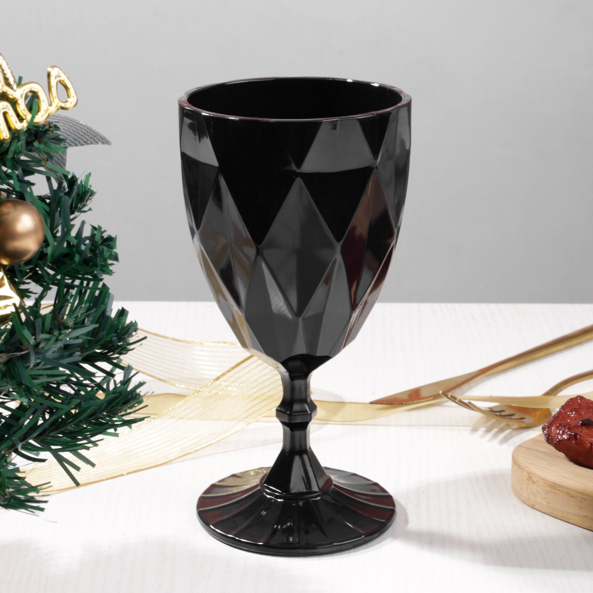 Black Vintage Acrylic Goblets (6 pcs/pk) on a table with gold silveware and christmas greens on top a white tabelcloth