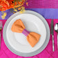 Mock up with the polyester orange napkin, white charger and fuchsia pintuck tablecloth