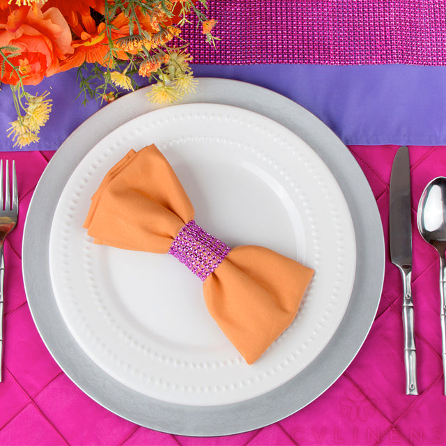 Mock up with the polyester orange napkin, white charger and fuchsia pintuck tablecloth