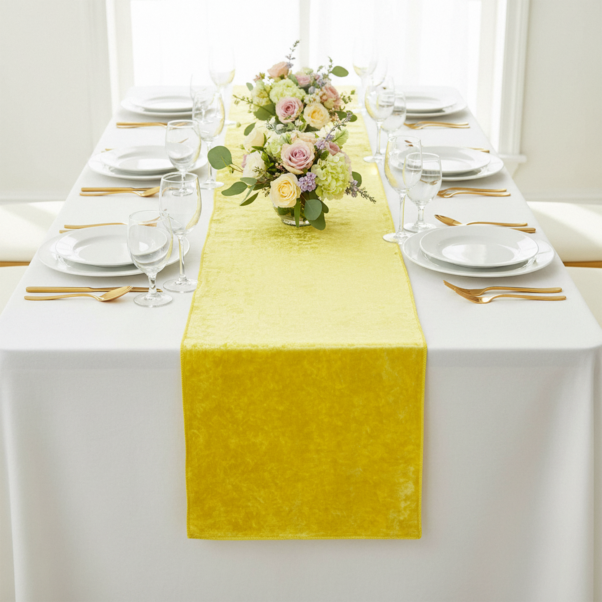 Velvet Table Runner Canary Yellow on top a white rectangular tablecloth with water goblets, white dinner plates and floral centerpiece
