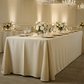 Scuba King 108"x156" Rectangular Tablecloth Champagen paired with white florals, wine glasses, and candles 