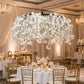 Cherry Blossom Ceiling Cascade White hanging above wedding table with mixed floral centerpieces, floating candles, and gold chiavari chairs