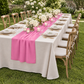 Pink chiffon runner at a garden wedding