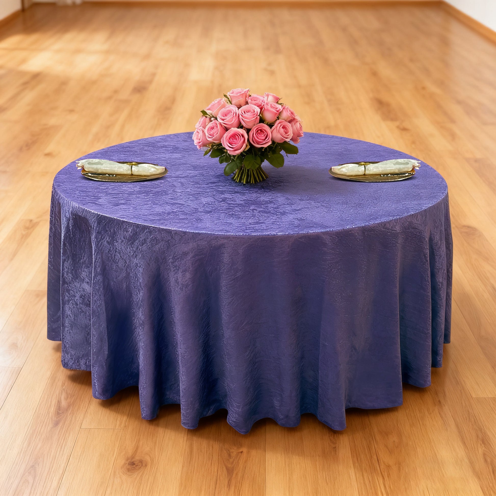 Crinkle Shimmer 120" Round Tablecloth Purple table setup with floral centerpiece, gold charger plates and ivory napkins