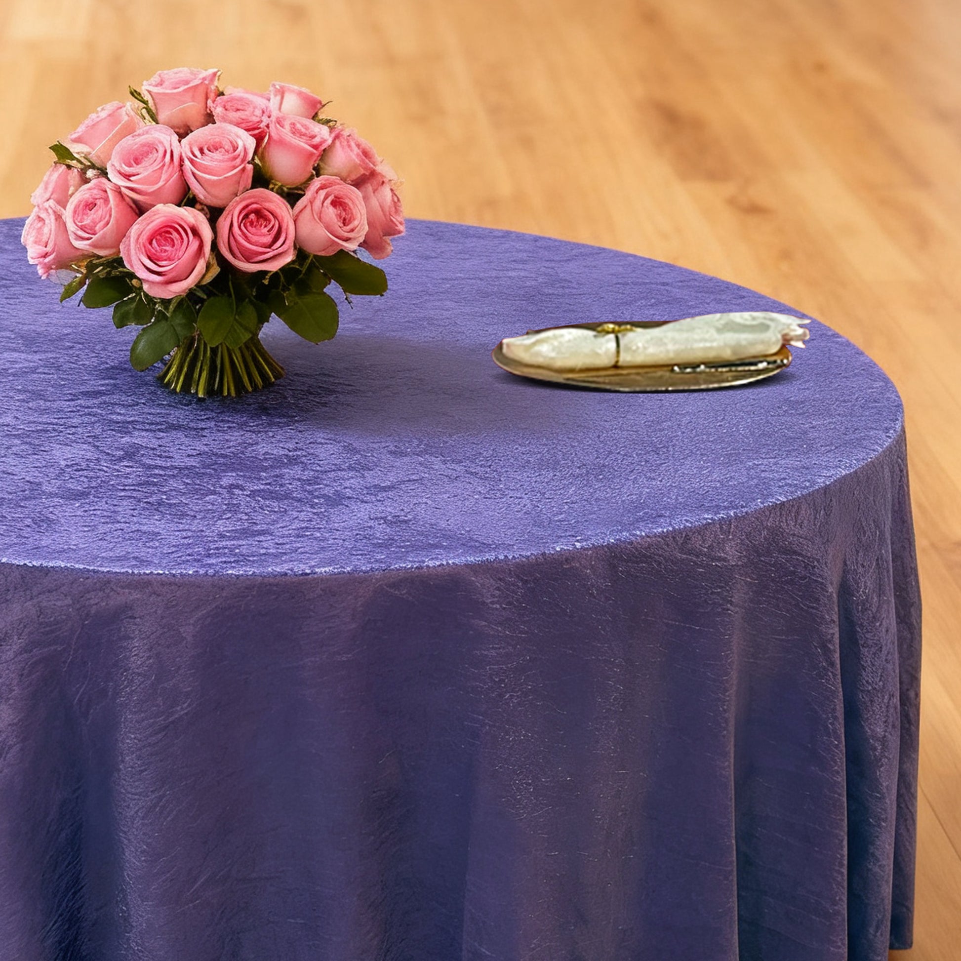 Crinkle Shimmer 120" Round Tablecloth Purple with floral centerpiece, gold charger plate and ivory napkin