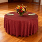 Crinkle Shimmer 132" Round Tablecloth Burgundy table setup with floral centerpiece, gold charger plates and ivory napkins
