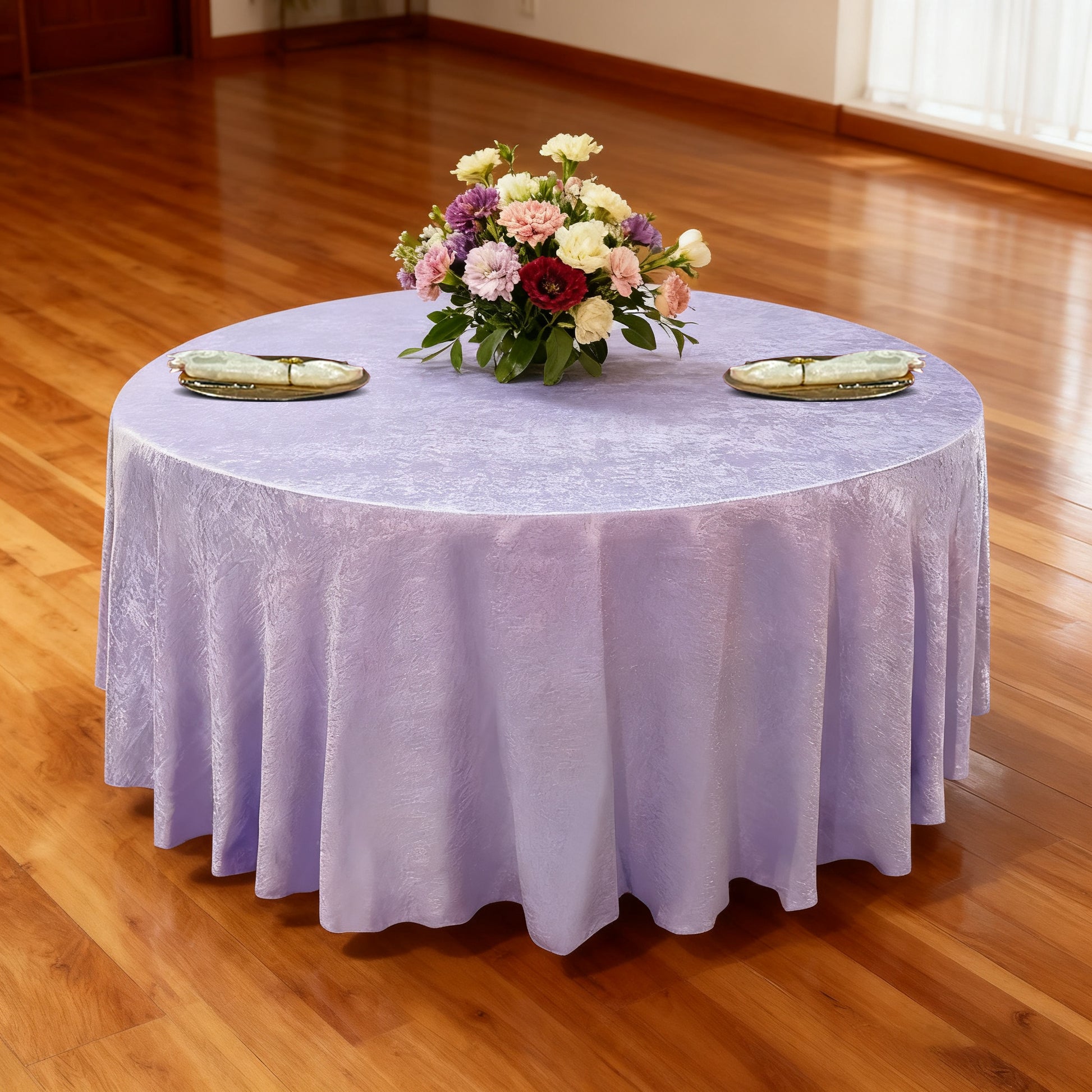 Crinkle Shimmer 132" Round Tablecloth Lavender table setup with floral centerpiece, gold charger plates and ivory napkins