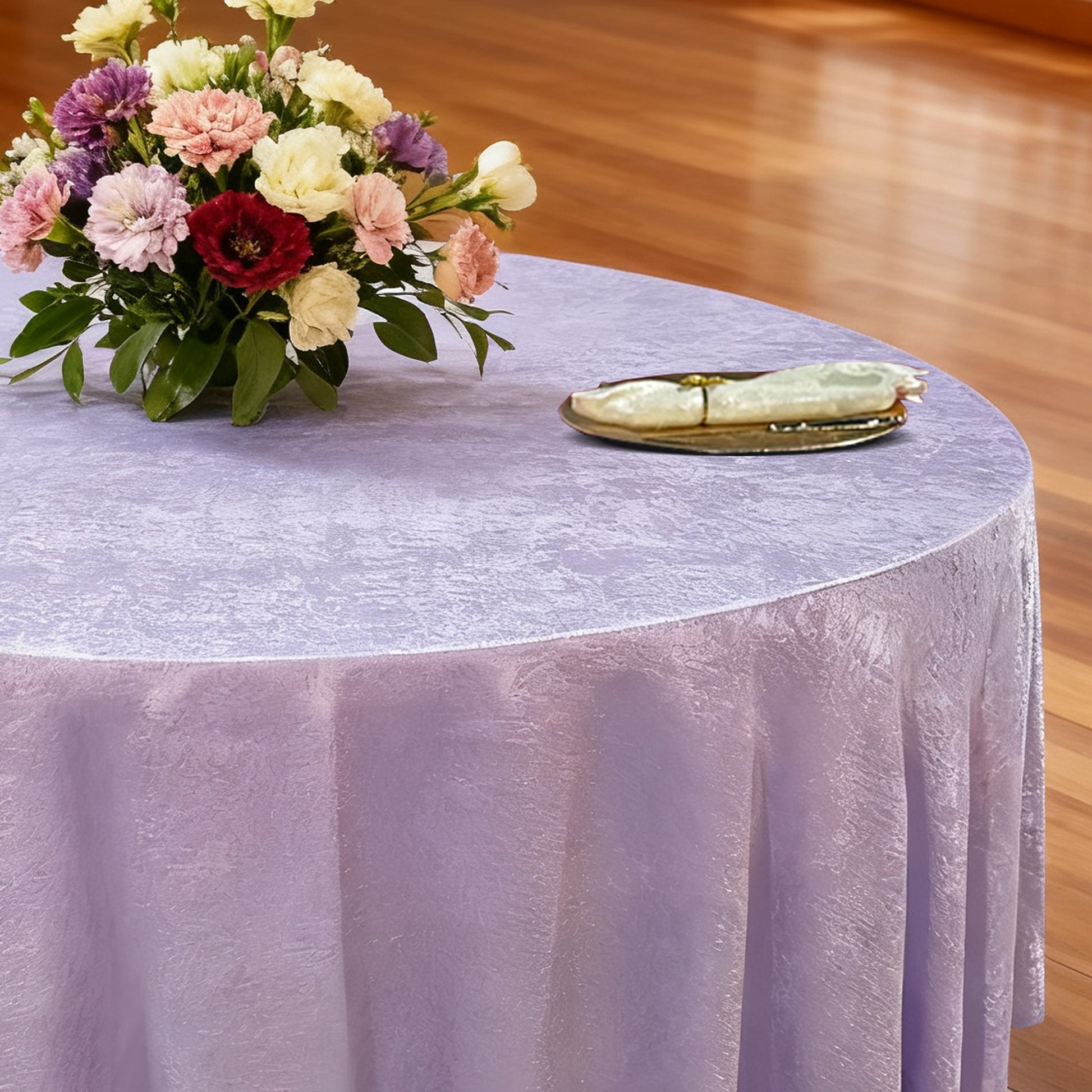 Crinkle Shimmer 132" Round Tablecloth Lavender with floral centerpiece, gold charger plate and ivory napkin
