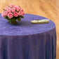 Crinkle Shimmer 132" Round Tablecloth Purple with floral centerpiece, gold charger plate and ivory napkin