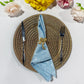 5 pcs/pk Crinkle Shimmer Napkin 20"x20" Baby Blue folded with bow gold napkin ring and gold charger plate
