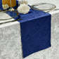Crinkle Shimmer Table Runner Royal Blue ontop a velvet silver tablelcoth, white roses, and charger plates.
