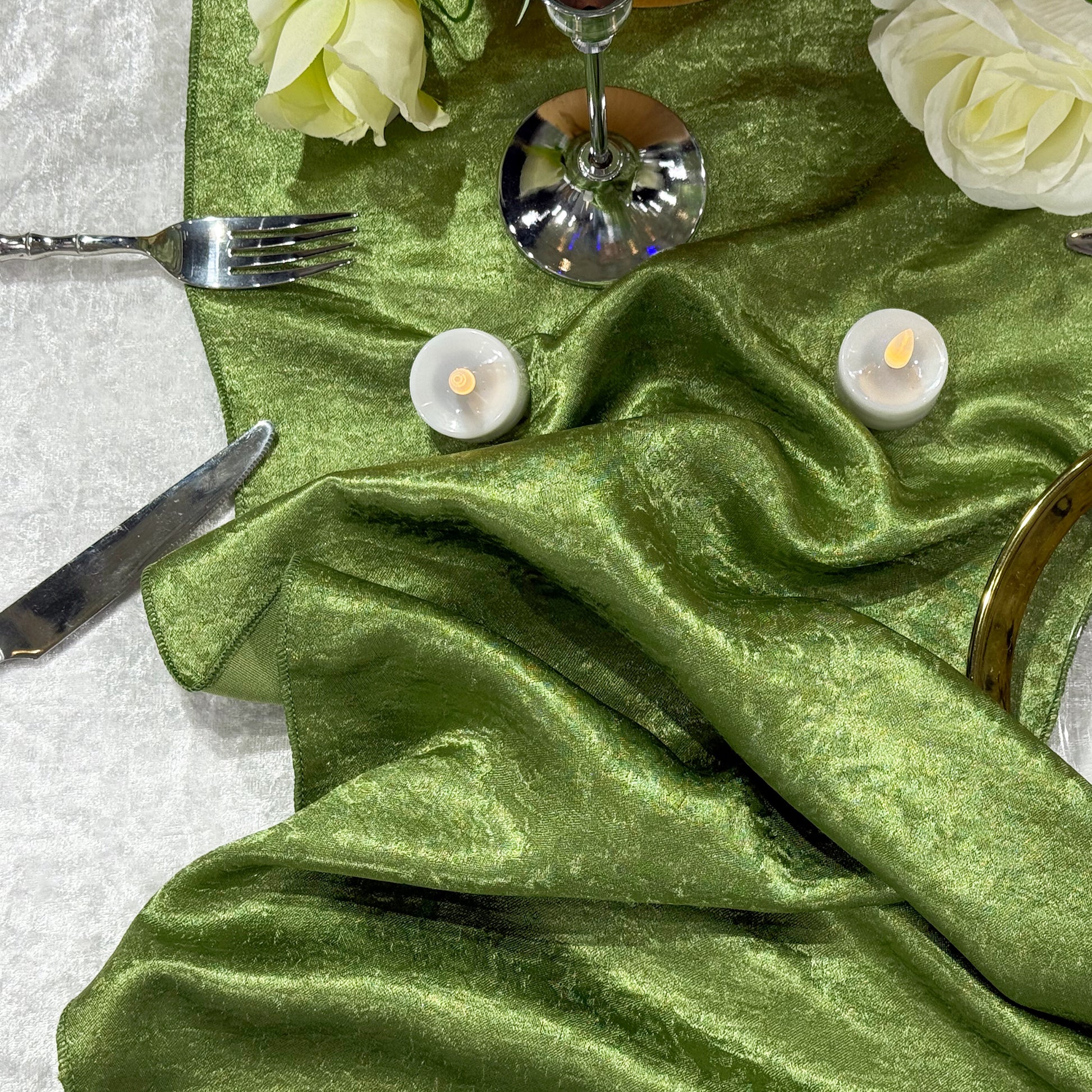 Crinkle Shimmer Table Runner Willow Green bunched with silver flatware, LED tea light candles