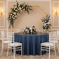Crushed Taffeta 132" Round Tablecloth - Navy Blue for indoor reception with gold trimmed charger plate | wine goblets | flower centerpiece