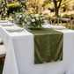 Velvet Table Runner Dark Sage Green on a white rectangular tablecloth, floral centerpieces and rustic barn style chairs