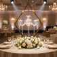 wedding reception table decor with Diamond Shape Centerpiece with Hanging Chandelier Gold, white florals, champagne glasses and dinner plates