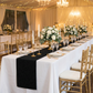 Embossed Geometric Jacquard Table Runner Black wedding reception table with tapered candles and centerpieces with white roses and eucalyptus