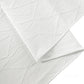 close up of the Embossed Geometric Jacquard Table Runner Light Ivory/Off White hemmed edge