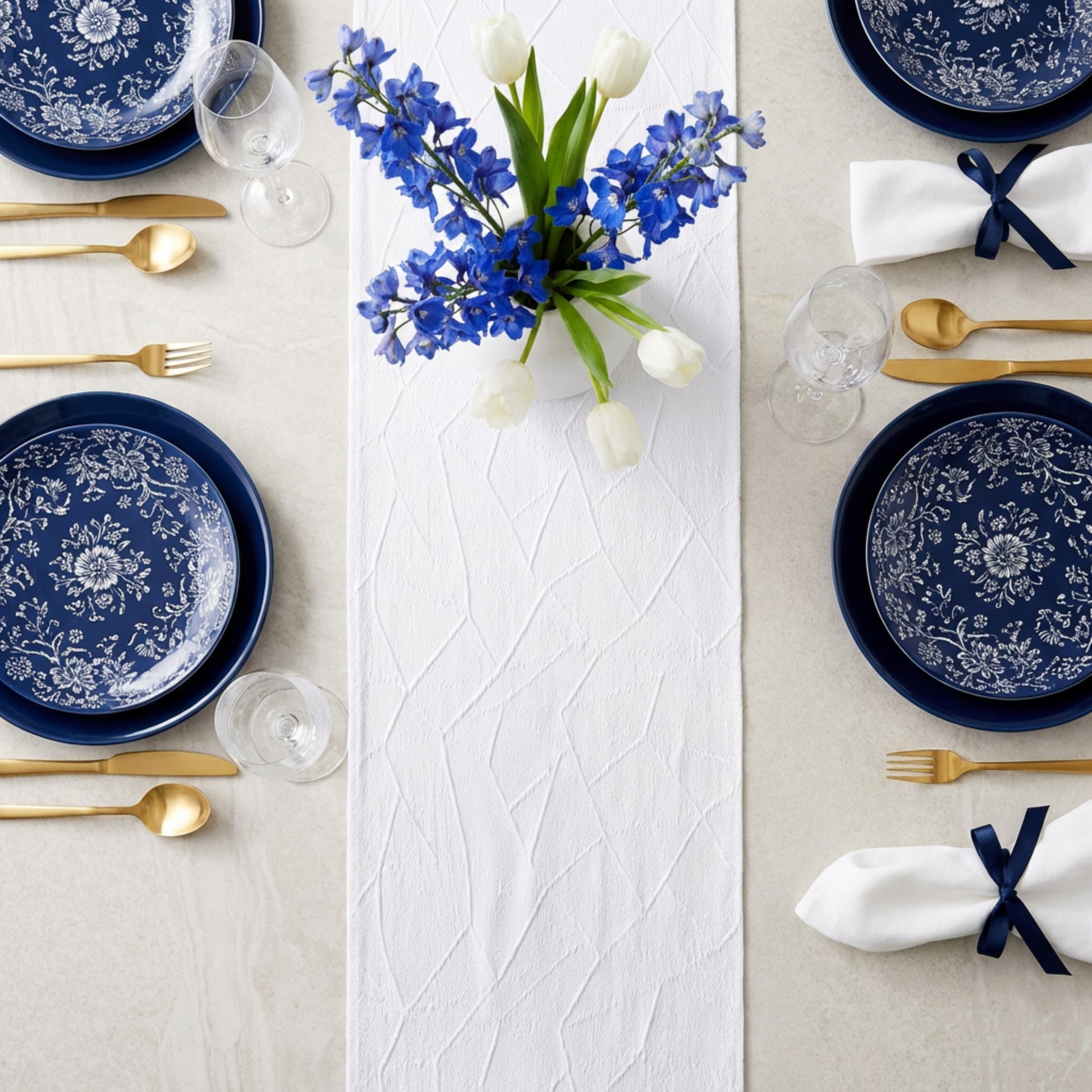 blue and white table setting using the Embossed Geometric Jacquard Table Runner White  