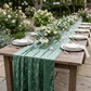 Velvet Table Runner Eucalyptus outdoor on a table with white dinner plates and white floral centerpieces
