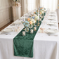 Velvet Table Runner Eucalyptus on top a white rectangular tablecloth

