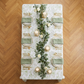 birds eye view of the French Toile 90"x132" Rectangular Tablecloth Sage Green with sage green napkins, rose floral centerpieces and pillar candles