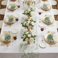 birds eye view wedding table setting with the French Toile Table Runner Sage Green, sage green napkins, gold silverware, and gold charger plates