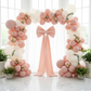 Giant Fabric Bow for Backdrop Blush/Rose Gold on sheer backdrop panels with balloons on the arch