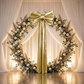 Giant Fabric Bow for Backdrop Metallic Gold in the center of a round arch with fall colored roses and pampas