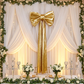 Giant Fabric Bow for Backdrop Metallic Gold backdrop with sheer draping, and greenery garland with LED curtain
