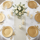 birds eye view of a table setting with Glitter Velvet Table Runner Ivory on top a round white tablecloth and paired with gold charger plates