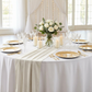 Glitter Velvet Table Runner Ivory on top a round white tablecloth paired with gold charger plates and sheer backdrop curtains