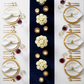 birds eye view of the Glitter Velvet Table Runner Navy Blue with floral centerpiece, white napkin and gold napkin rings