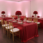 Glitz Sequin 90"x156" Rectangular Tablecloth - Apple Red with flower centerpiece | white dinner plate | wine goblets | gold charger plate | gold chiavari chair