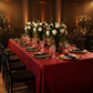Glitz Sequin 90"x156" Rectangular Tablecloth - Red with gold charger plate | white dinner plate | black napkin | black chiavari chair | wine goblets