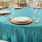 Glitz Sequins 120" Round Tablecloth - Turquoise close up view with gold charger plate
