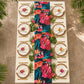 Hawaiian Tahiti Floral Scuba Table Runner on a rectangular table with rattan placemats and tropical floral centerpiece birdseye view
