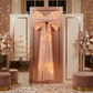 LED Chiffon Bow for Backdrop Blush/Rose Gold on a backdrop stand