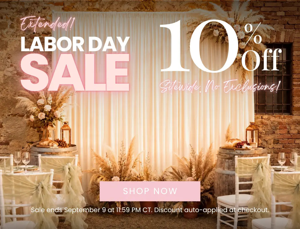 Labor Day sale banner with 10% off sitewide, pink Shop Now button, elegant rustic backdrop, floral decor and banquet tables.