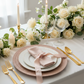 Lace Embossed  Acrylic Plastic Charger Plate Pink Blush table setting with white dinner plates, gold silverware, tapered candles, wine glasses and a white rose floral centerpiece
