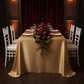 Lamour Satin 90"x132" Rectangular Oblong Tablecloth - Gold Antique with gold charger plate | white napkin | wine goblets | white chiavari chairs | floral premade runners