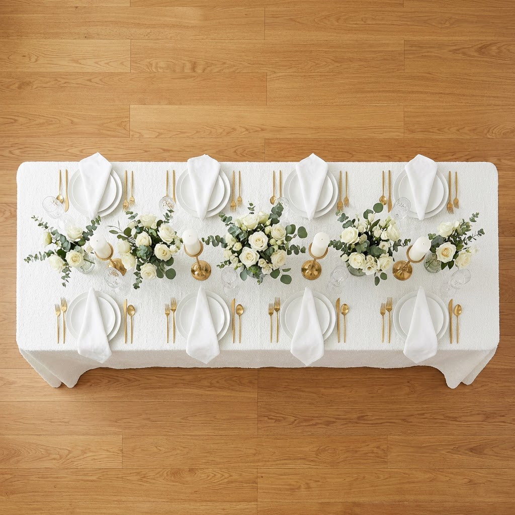 birdseye view of the Luxury Boucle Rectangular Tablecloth White with dinner plates, white napkins and water glasses