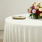 Luxury Boucle Round Tablecloth Beige with floral centerpiece, gold charger plate and ivory napkin with a gold napkin ring