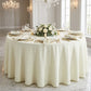 Luxury Boucle Round Tablecloth Ivory on a round table with gold charger plates